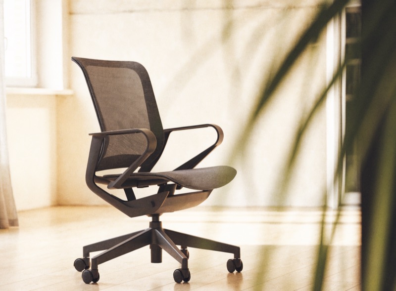 An ergonomic mesh office chair in a bright minimal home office
